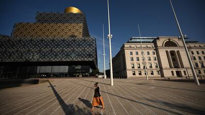 A pedestrian walks in Birmingham, central England, after the British government imposed fresh restrictions on the city following a surge in cases. AFP