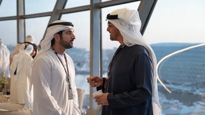 Sheikh Mohamed speaks with Sheikh Hamdan bin Mohammed, Crown Prince of Dubai, in Shams Tower at Yas Marina Circuit. Hamad Al Kaabi / Presidential Court