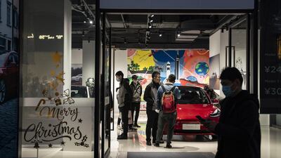 Customers and staff at a Tesla showroom in Shanghai, China. The California-based electric vehicle maker's recent stock surge has put its market value at about $630 billion. Bloomberg