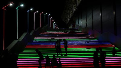 People enjoy stairs with coloured lights at a baseball stadium in La Guaira, Venezuela, amid the coronavirus pandemic. AP