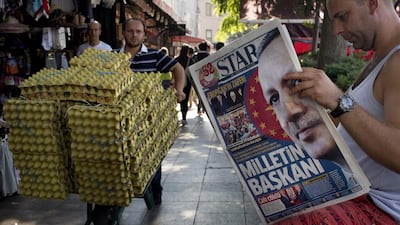 A man reads a newspaper in central Istanbul on August 11. AP Photo