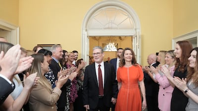 Mr and Mrs Starmer are applauded by Downing Street staff as they enter
