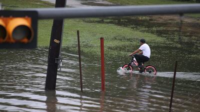A boy on a bike rides in the flooded waters on Hopper Rd. on September 19, 2019 in Houston, Texas. Getty Images