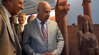 Ahmed Fakak al-Badrani, Iraqi Minister of Culture, Tourism and Antiquities, tours an exhibit at the Mosul Museum. AFP