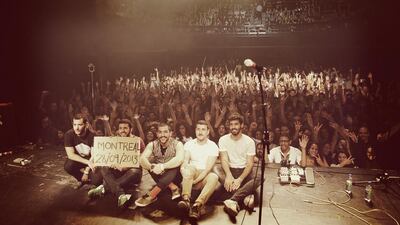 Members of the band Mashrou’ Leila, whose songs sung in Arabic about politics, war, class, sex, poverty and sectarianism have earned them a loyal following among Arab youth, pose for a photo at a concert last month in Montreal, Canada. The group’s lead singer, Hamid Sinno, is seated at centre. Courtesy Mashrouh' Leila