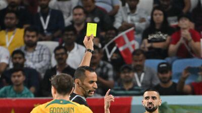 Referee Mustapha Ghorbal shows a yellow card to Australia's Aziz Behich in the first half. AFP