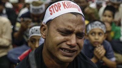 A Rohingya man cries as he prays during a protest condemning Myanmar's government violence on his people. Fazry Ismail / EPA
