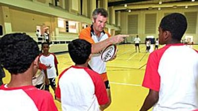 Frank Hadden coaches local students in Dubai on basic rugby skills.