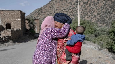 Earthquake survivors embrace each other. AFP