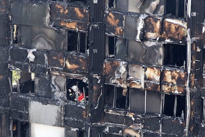 A firefighter investigates after the inferno engulfed the 24-storey Grenfell Tower in west London. PA