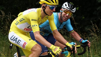 UAE Team Emirates rider Tadej Pogacar wearing the overall leader's yellow jersey with Astana Qazaqstan Team's Mark Cavendish during Stage 5. AFP