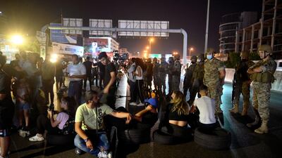 Lebanese army soldiers intervene as anti-government protesters attempt to block the main highway during a protest to demand a change of the sectarian system and finding solutions to the daily-living and economic crisis in Jal El Dib area north of in Beirut. EPA