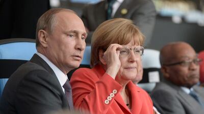 Russia’s president, Vladimir Putin and the German Chancellor, Angela Merkel watch the match. EPA