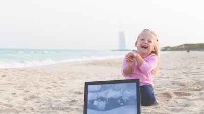 Little Cara holds a photo of herself after being born at 26 weeks. Courtesy JewelSeddon Photography