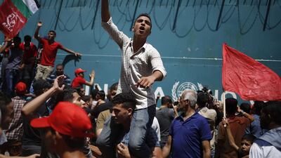 Palestinians supporting the Popular Front for the Liberation of Palestine take part in a protest against the reduction of educational programs given by the United Nations Relief and Works Agency outside the UNRWA headquarters in Gaza City. AFP