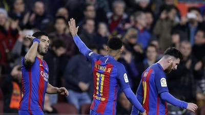 Luis Suarez, left, celebrates with Neymar and Lionel Messi after scoring. Manu Fernandez / AP Photo
