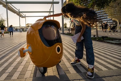 A visitor interacts with Opti the robot at the Mobility District, Expo 2020 Dubai. Photo: Expo 2020 Dubai