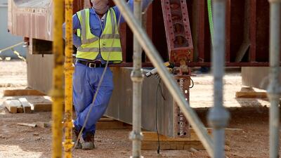 An Asian labourer looks up as he works at the construction site of a building in Riyadh, Saudi Arabia. Faisal Al Nasser / Reuters