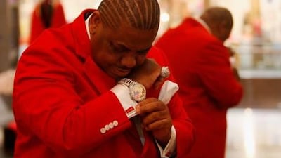 Bling is the thing … the style icon Mohammed al Balooshi dazzles in red inside his shop Gizia in Dubai Mall. He spends an average of Dh10,000 a week on clothes.