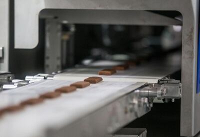 Snack bars made from dates on the production line at the factory. Leslie Pableo / The National