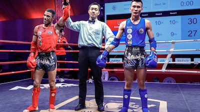 UAE's Zakaria Eljamari, left, defeated Yu Xi Chen during the second day of the IFMA Asian Championship in Abu Dhabi. Victor Besa / The National