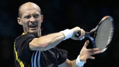 Nikolay Davydenko of Russia plays a return to Sweden's Robin Soderling during their ATP World Tour Finals tennis match at the O2 Arena in London.