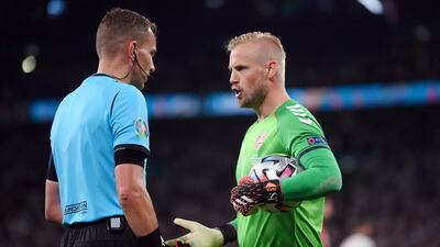 Denmark goalkeer Kasper Schmeichel speaks to referee Danny Makkelie after England were awarded a penalty in the Euro 2020 semi-final. Reuters