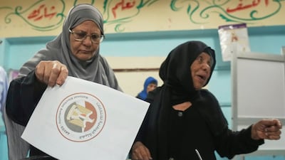 A voter casts their ballot at a polling station in Cairo. AP