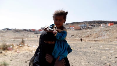 A displaced Yemeni woman carries her child at a camp for Internally Displaced Persons (IDPs) on the outskirts of Sana'a, Yemen. EPA