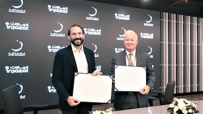 Ussama Dahabiyeh, chief executive of Injazat, and Clayton MacKenzie, provost and chief academic officer at Zayed University, at the signing ceremony. Photo: Injazat