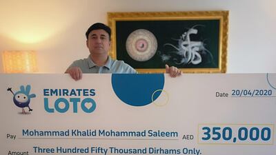 Mohammed Khalid with his cheque for Dh350,000. Courtesy: Emirates Loto