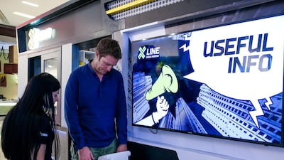 The National reporter, Nick Webster, gets weighed before a jump down the world's longest urban zipline. Victor Besa for The National