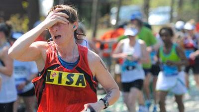 A runner feels the heat along the route of the Boston Marathon.