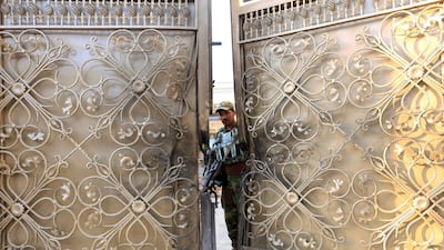 An Afghan security guard stands at the gate of a midwife training center after an attack in Jalalabad city, Afghanistan. Parwiz/Reuters