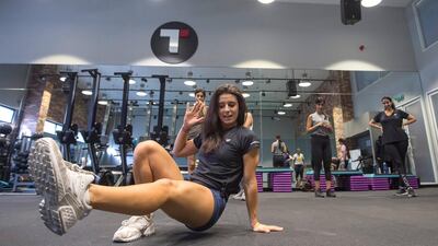 Fitness coach Holly Lohmeyer demonstrates the right form to the women exercising at GetFitChick. Leslie Pableo for The National