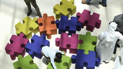 A child tries to solve a puzzle – or perhaps he is simply building a bigger seat – at one of Dubai Saturday Club’s workshops that encouraged children to think about the future. Jeffrey E Biteng / The National
