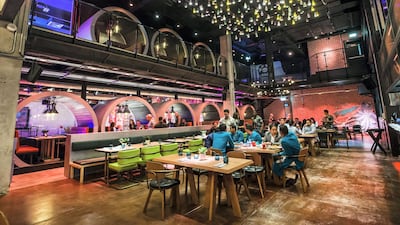 Outside, it's more of a rustic beach bar, while inside the vibe is more industrial gastropub. Leslie Pableo / The National