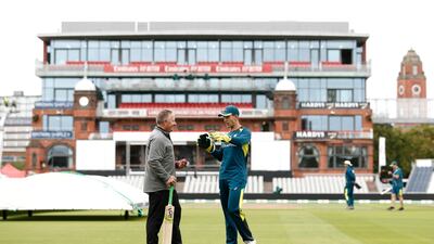 Former Australian Wicketkeeper Ian Healy, left, speaks with current captain Tim Paine during training at Old Trafford on Tuesday. Getty