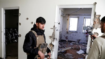 An Afghan policeman inspects the site after yesterday's attack at the university of Kabul. Reuters