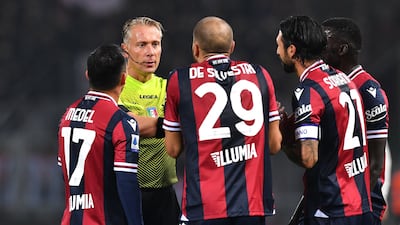 Bologna players remonstrate with referee Paolo Valeri before he shows Roberto Soriano a red card. Reuters