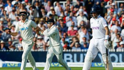 England's Joe Root (R) walks back to the pavilion after being caught out by New Zealand's Tim Southee. AFP