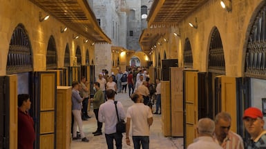 People walk around the reopened Souq Khan Al Harir market in Syria's northern city of Aleppo. AFP