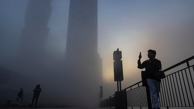 A resident takes a picture of dense fog which engulfed Dubai on Saturday morning. All photos: Antonie Robertson / The National