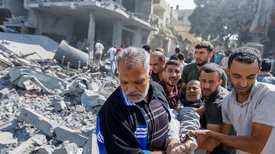 Palestinians carry a wounded man following Israeli strikes in Rafah, southern Gaza Strip. Reuters