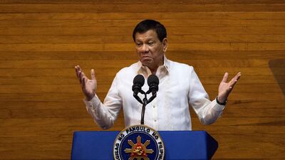 This photo taken on July 24, 2017 shows Philippine president Rodrigo Duterte gesturing as he delivers his state of the nation address at Congress in Manila. Mr Duterte has said he would not co-operate with a special anti-corruption prosecutor's investigation into allegations he acquired ill-gotten wealth. Noel Celis / AFP
