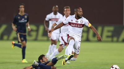 Ismail Matar, right, of Al Wahda jumps over a Dubai defender during their Arabian Gulf League match at Al Nahyan Stadium in Abu Dhabi on May 2, 2014. Shadi Malkawi / Al Ittihad