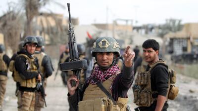 Members of Iraq’s elite counter-terrorism service secure the Hoz neighbourhood in central Ramadi, the capital of Iraq’s Anbar province, on December 27, 2015, during military operations conducted by Iraqi pro-government forces against ISIL. Jihadist fighters abandoned their last stronghold in Ramadi on Monday, bringing Iraqi federal forces within sight of their biggest victory since last year’s massive offensive by ISIL. Ahmad Al Rubaye / Agence France-Presse