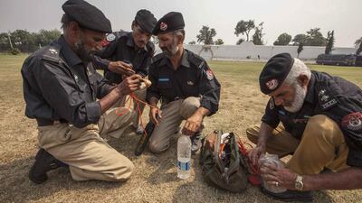 Technicians from Pakistan’s top bomb disposal unit prepare an improvised detonator, by fixing a cord into a plastic water bottle, to demonstrate how to destroy bombs at the unit’s headquarters in Peshawar. Zohra Bensemra / Reuters