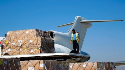 A technician unloads doses of vaccines from a UN aid plane after it landed in Sanaa on November 25, 2017. Mohammed Huwais / AFP