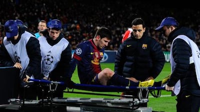Barcelona's Lionel Messi is stretchered off against Benfica.